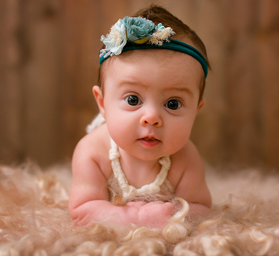 Man and woman holding a dog and a baby