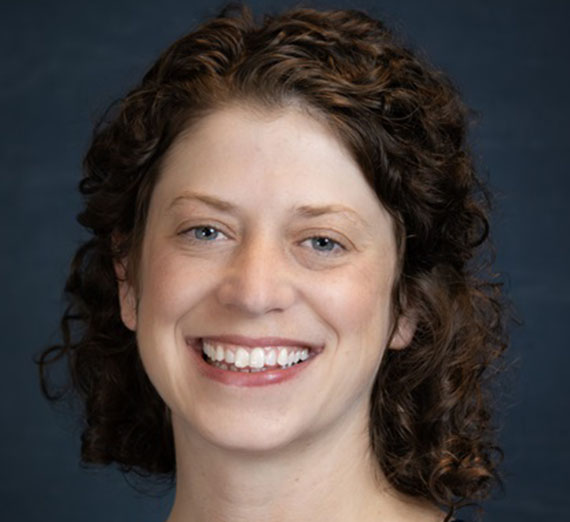 Brenna Messner sitting in nursing lab looking away from the camera.
